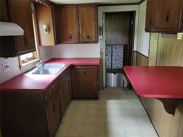 214 Washington Ave, Mount Pleasant Twp Was, PA 15340 - kitchen featuring wallpapered walls, range hood, a sink, light flooring, and dark brown cabinets