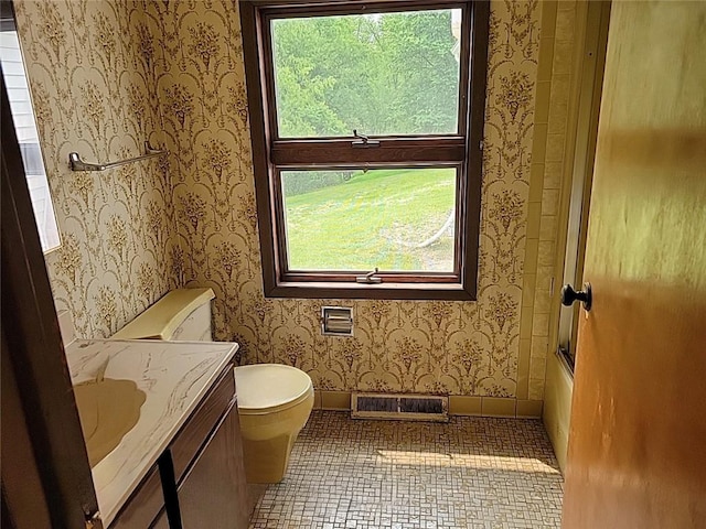 214 Washington Ave, Mount Pleasant Twp Was, PA 15340 - full bathroom with wallpapered walls, toilet, vanity, washtub / shower combination, and tile patterned flooring