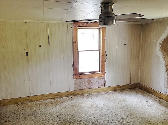 214 Washington Ave, Mount Pleasant Twp Was, PA 15340 - carpeted empty room with wooden walls, baseboards, and a ceiling fan