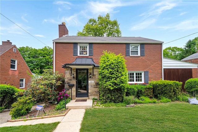166 Spring Grove Rd, Penn Hills, PA 15235 - view of front of house featuring a front yard, a chimney, and brick siding