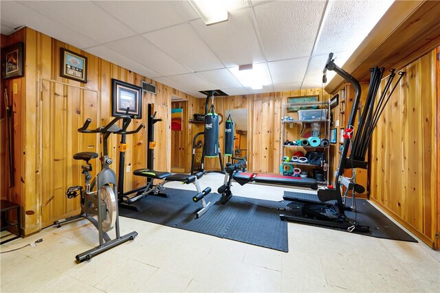 166 Spring Grove Rd, Penn Hills, PA 15235 - workout room with wooden walls, tile patterned floors, and a paneled ceiling