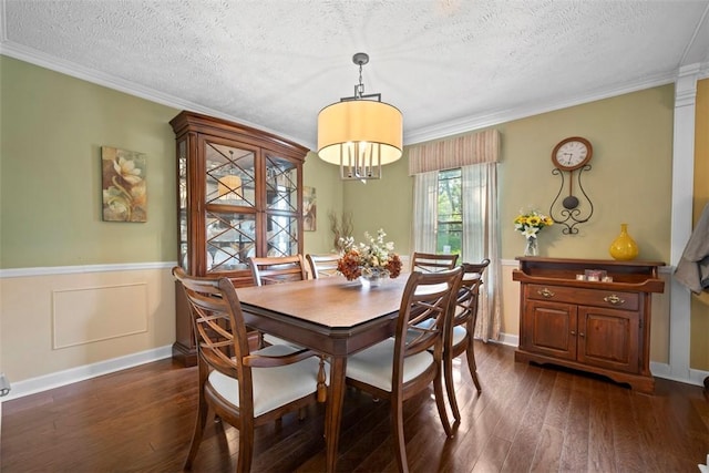 208 Ruffed Grouse Dr, North Fayette, PA 15126 - dining area with dark wood-style flooring, a textured ceiling, crown molding, and a wainscoted wall