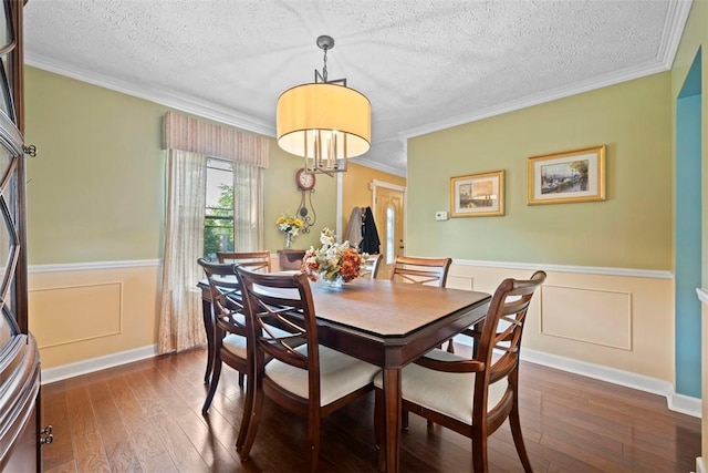 208 Ruffed Grouse Dr, North Fayette, PA 15126 - dining room featuring dark wood-style flooring, a textured ceiling, wainscoting, and ornamental molding
