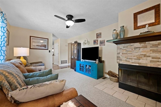 208 Ruffed Grouse Dr, North Fayette, PA 15126 - living room with a ceiling fan, a textured ceiling, light carpet, and a fireplace with flush hearth