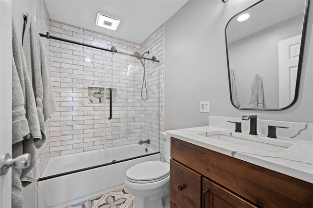 208 Ruffed Grouse Dr, North Fayette, PA 15126 - bathroom with vanity, bath / shower combo with glass door, and toilet