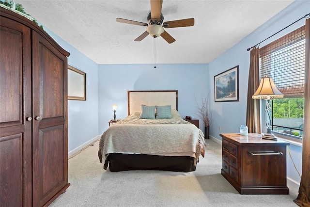 208 Ruffed Grouse Dr, North Fayette, PA 15126 - bedroom with baseboards, light colored carpet, ceiling fan, and a textured ceiling