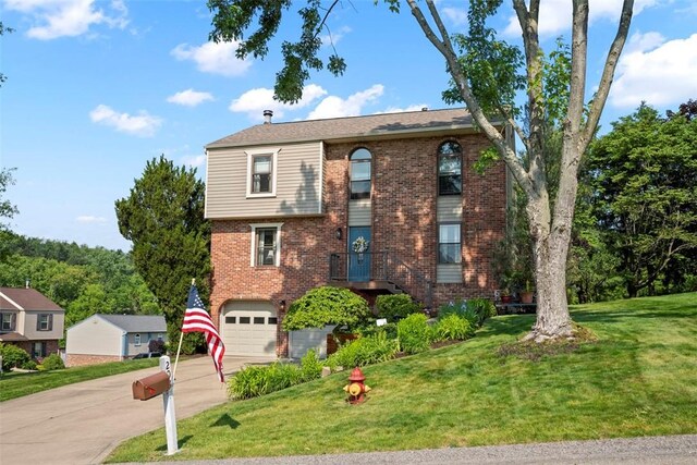 208 Ruffed Grouse Dr, North Fayette, PA 15126 - view of front of property with concrete driveway, a garage, brick siding, and a front lawn