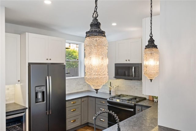 323 44th St, Lawrenceville, PA 15201 - kitchen with stainless steel refrigerator with ice dispenser, gas range, wine cooler, dark countertops, and white cabinetry