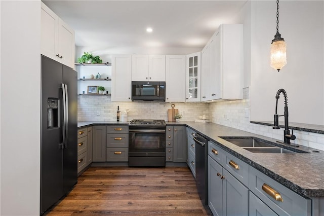 323 44th St, Lawrenceville, PA 15201 - kitchen with black fridge, range with gas stovetop, a sink, dishwasher, and dark countertops