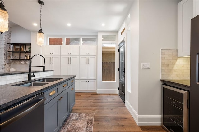 323 44th St, Lawrenceville, PA 15201 - kitchen featuring dishwasher, beverage cooler, a sink, dark countertops, and tasteful backsplash