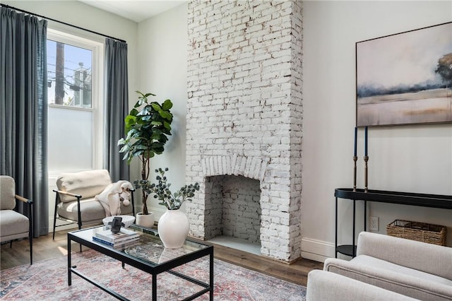 323 44th St, Lawrenceville, PA 15201 - living area featuring wood finished floors, a fireplace, and baseboards