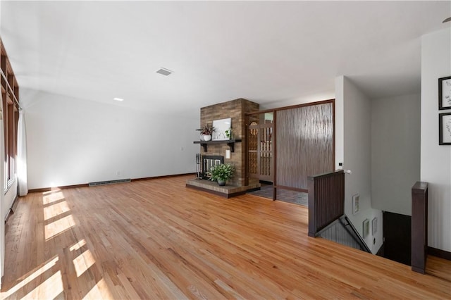 102 Colwyn Rd, Ross Twp, PA 15237 - unfurnished living room with wood finished floors, a fireplace, and baseboards