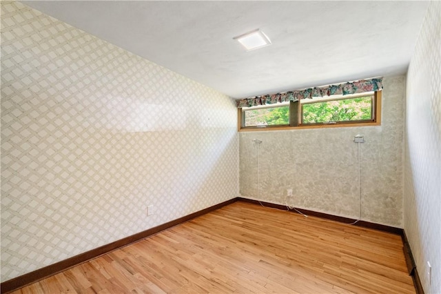 102 Colwyn Rd, Ross Twp, PA 15237 - empty room with light wood-style flooring, wallpapered walls, and baseboards