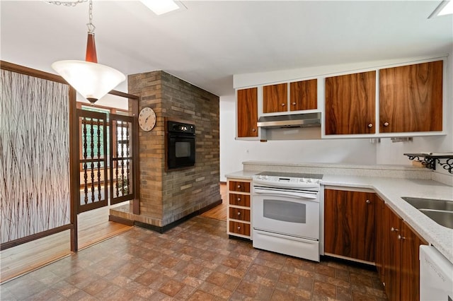 102 Colwyn Rd, Ross Twp, PA 15237 - kitchen with white appliances, under cabinet range hood, stone finish floors, brown cabinets, and light countertops