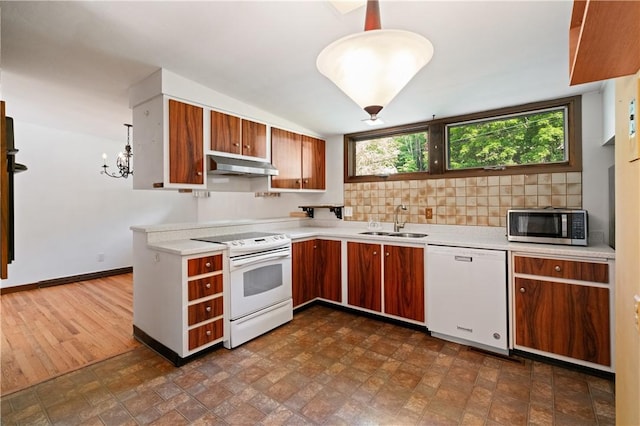 102 Colwyn Rd, Ross Twp, PA 15237 - kitchen featuring white appliances, under cabinet range hood, a sink, light countertops, and backsplash