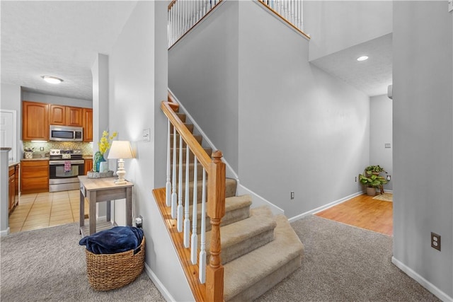 254 Maple Ridge Dr, Cecil, PA 15317 - stairway featuring carpet flooring, a towering ceiling, and baseboards