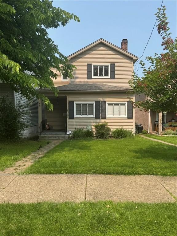 623 5th St, Oakmont, PA 15139 - view of front of home featuring a chimney, a front yard, and covered porch