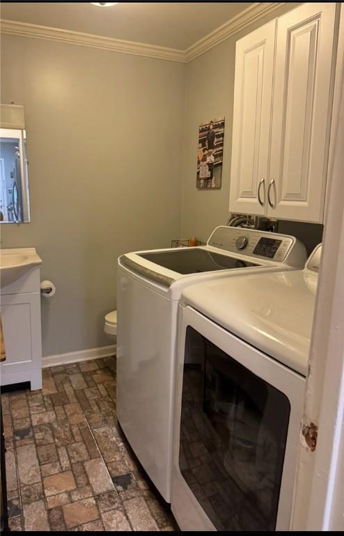623 5th St, Oakmont, PA 15139 - laundry area with washer and clothes dryer, brick flooring, ornamental molding, and baseboards
