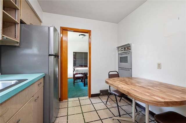 109 Mattier Dr, Ohara, PA 15238 - kitchen featuring freestanding refrigerator, light carpet, light countertops, and light brown cabinetry