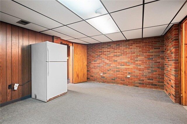 109 Mattier Dr, Ohara, PA 15238 - finished basement featuring brick wall, freestanding refrigerator, carpet, wooden walls, and a paneled ceiling