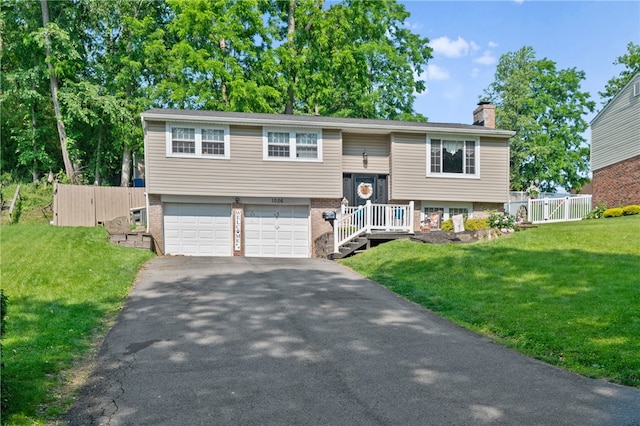 1006 Willow Glen Dr, Bethel Park, PA 15102 - raised ranch with asphalt driveway, an attached garage, a chimney, and brick siding