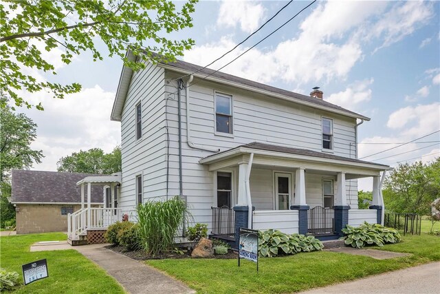169 Plum Way, Wayne Twp Law, PA 16157 - american foursquare style home featuring covered porch, a front lawn, and a chimney