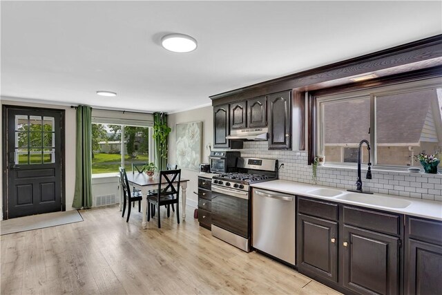 169 Plum Way, Wayne Twp Law, PA 16157 - kitchen featuring stainless steel appliances, a sink, under cabinet range hood, light countertops, and ornamental molding