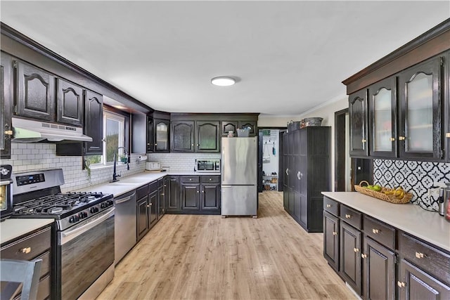 169 Plum Way, Wayne Twp Law, PA 16157 - kitchen featuring stainless steel appliances, a sink, under cabinet range hood, ornamental molding, and decorative backsplash