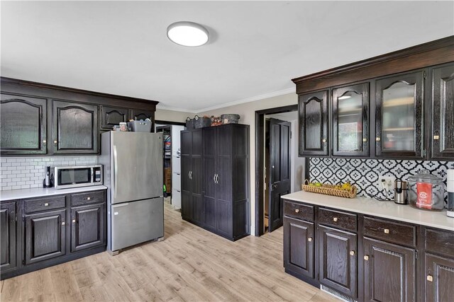 169 Plum Way, Wayne Twp Law, PA 16157 - kitchen with appliances with stainless steel finishes, light countertops, ornamental molding, backsplash, and glass insert cabinets