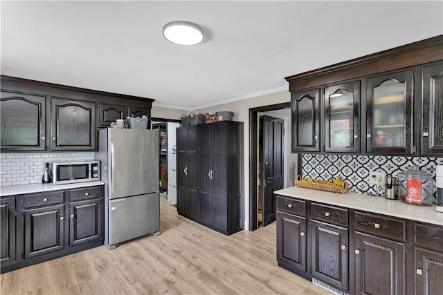 169 Plum Way, Wayne Twp Law, PA 16157 - kitchen with appliances with stainless steel finishes, light countertops, ornamental molding, backsplash, and glass insert cabinets