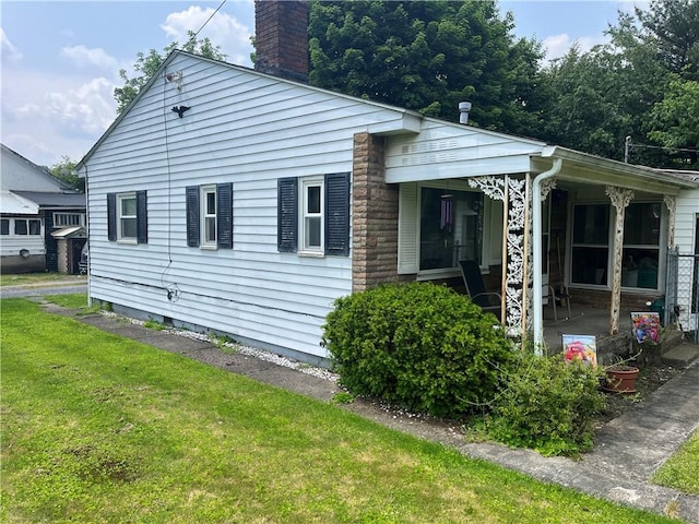 807 Sutton St, Punxsutawney Area School District, PA 15767 - view of side of property with a chimney and a yard