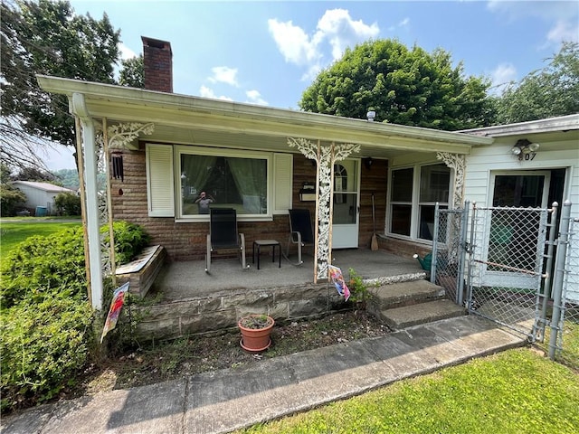 807 Sutton St, Punxsutawney Area School District, PA 15767 - back of property with covered porch and a chimney