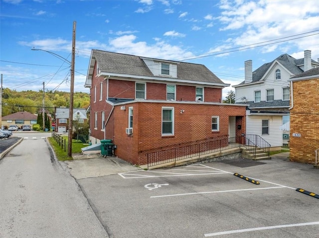 1632 Lincoln Way, White Oak, PA 15131 - view of side of home featuring uncovered parking, brick siding, and roof with shingles
