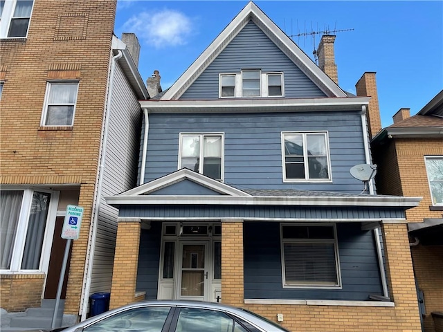 3884 E St, Perry Hilltop, PA 15214 - back of property with brick siding, a chimney, and a porch