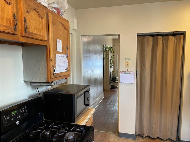 3884 E St, Perry Hilltop, PA 15214 - kitchen featuring black appliances and brown cabinetry