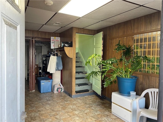 3884 E St, Perry Hilltop, PA 15214 - below grade area with wooden walls, a drop ceiling, and stairs