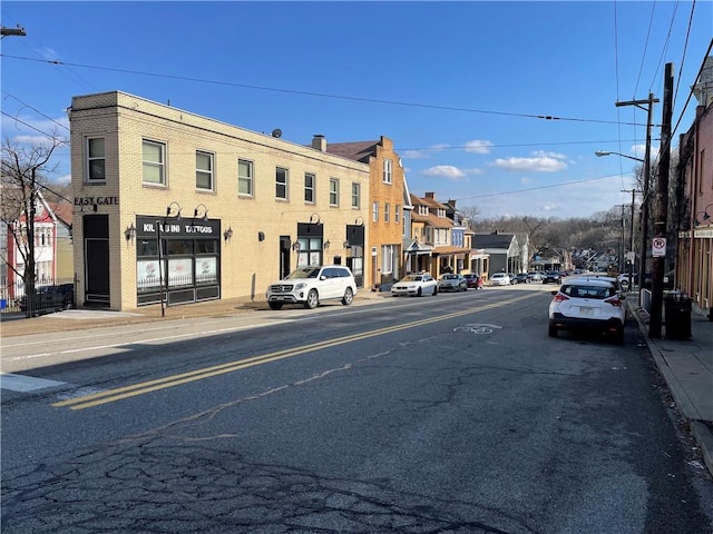 3884 E St, Perry Hilltop, PA 15214 - view of asphalt road featuring sidewalks, street lighting, and curbs