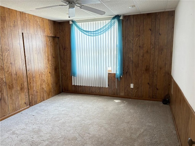 3884 E St, Perry Hilltop, PA 15214 - carpeted spare room featuring wood walls and a ceiling fan