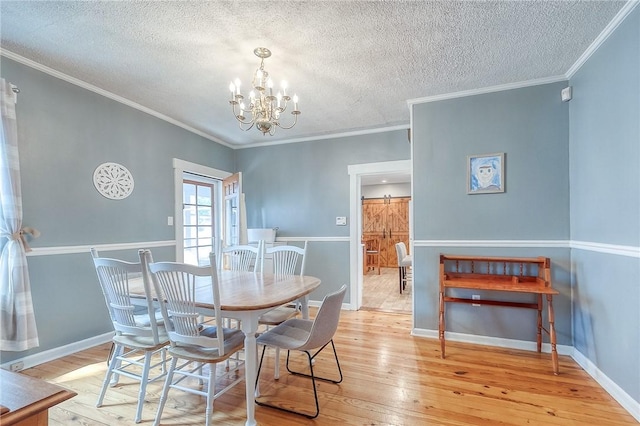 429 Market St, Beaver, PA 15009 - dining space with light wood-type flooring, a chandelier, a textured ceiling, crown molding, and baseboards
