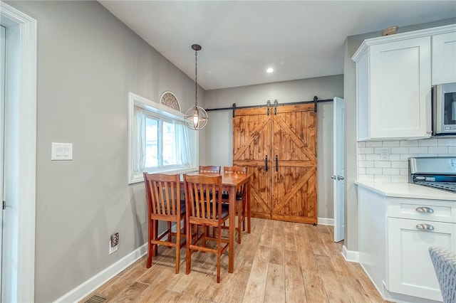 429 Market St, Beaver, PA 15009 - dining area with light wood-type flooring, a barn door, baseboards, and recessed lighting
