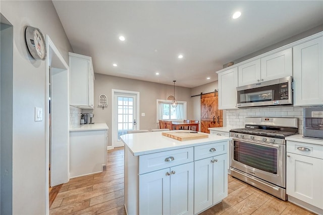 429 Market St, Beaver, PA 15009 - kitchen featuring appliances with stainless steel finishes, white cabinetry, backsplash, light wood finished floors, and recessed lighting