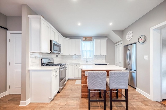 429 Market St, Beaver, PA 15009 - kitchen featuring stainless steel appliances, a center island, light countertops, tasteful backsplash, and light wood finished floors