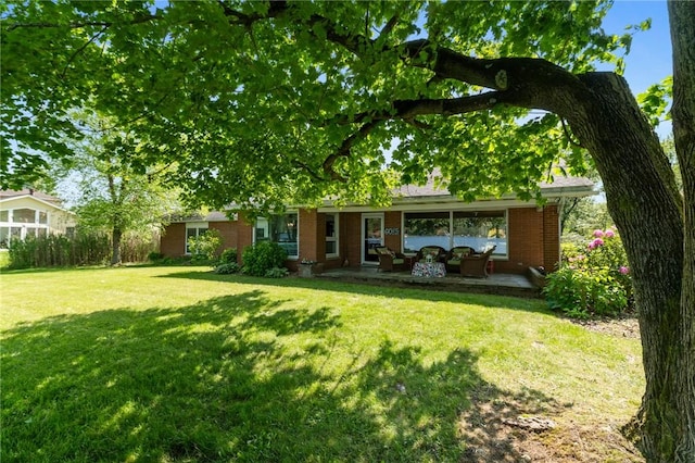 10756 Aldina Dr, Conneaut Lake, PA 16316 - rear view of house featuring an outdoor living space, a yard, brick siding, and a patio