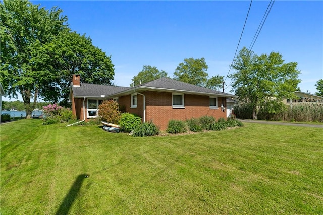 10756 Aldina Dr, Conneaut Lake, PA 16316 - ranch-style home with brick siding, a front lawn, and a chimney