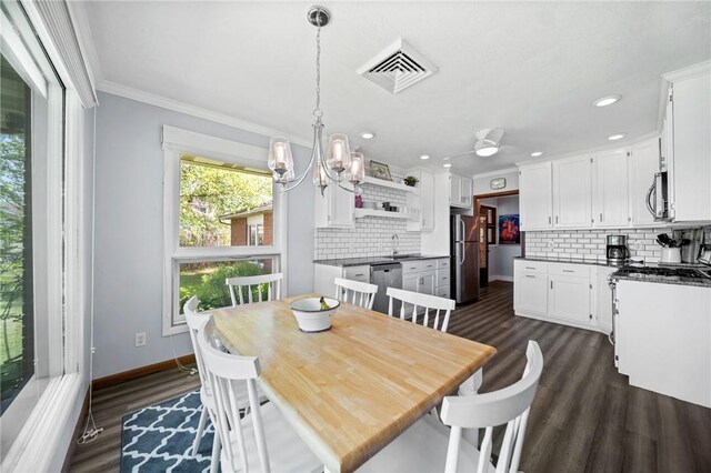 10756 Aldina Dr, Conneaut Lake, PA 16316 - dining area with dark wood finished floors, baseboards, ornamental molding, recessed lighting, and a chandelier