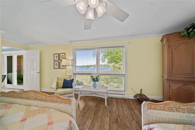 10756 Aldina Dr, Conneaut Lake, PA 16316 - bedroom with wood finished floors, baseboards, crown molding, a baseboard radiator, and a ceiling fan
