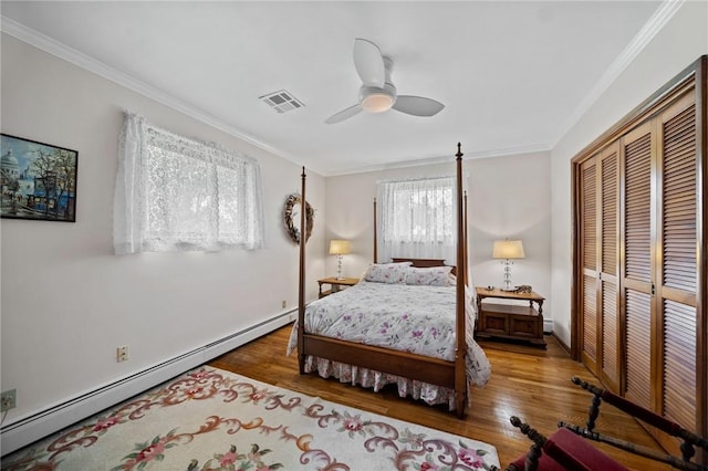 10756 Aldina Dr, Conneaut Lake, PA 16316 - bedroom featuring a baseboard radiator, a closet, wood finished floors, ornamental molding, and ceiling fan