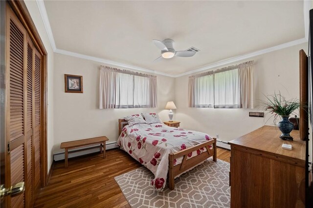 10756 Aldina Dr, Conneaut Lake, PA 16316 - bedroom with a closet, wood finished floors, ornamental molding, a baseboard heating unit, and baseboard heating