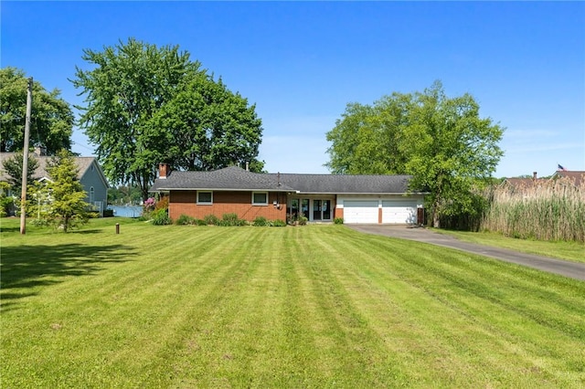 10756 Aldina Dr, Conneaut Lake, PA 16316 - ranch-style home with an attached garage, driveway, a front lawn, a chimney, and brick siding