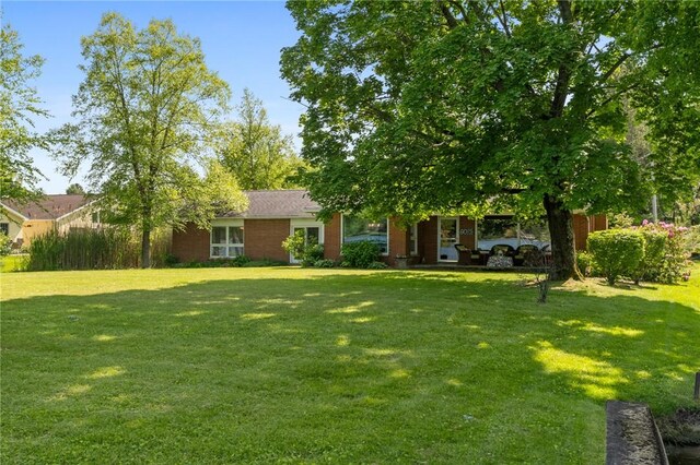 10756 Aldina Dr, Conneaut Lake, PA 16316 - view of front facade featuring a front yard and brick siding